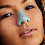 Load image into Gallery viewer, girl wearing blue Noz sunscreen that is eco friendly on her nose. 
